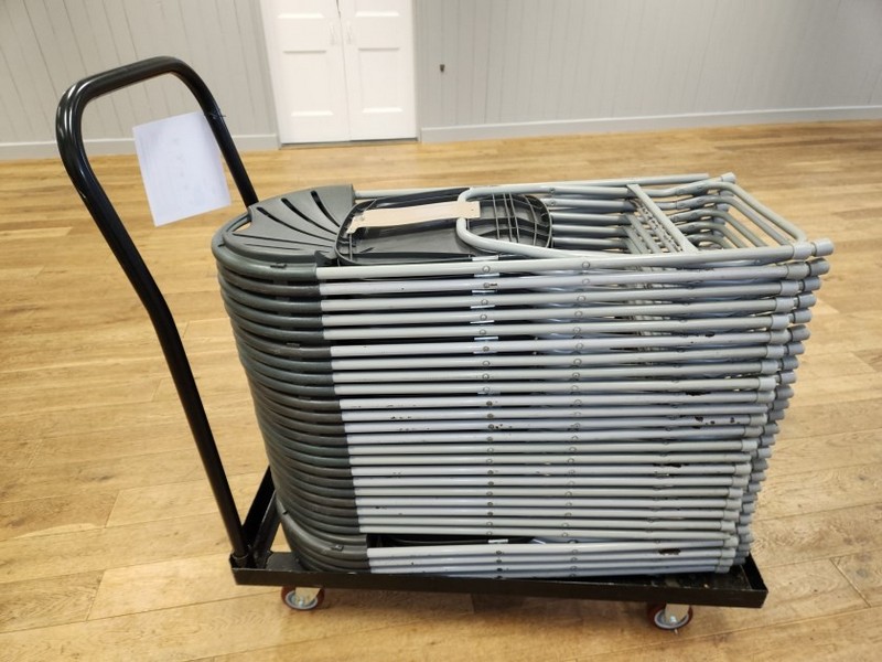 90+ metal framed, plastic seated folding chairs are stored on trolly’s in the main store room