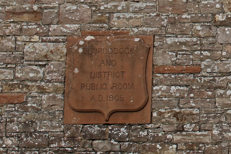 Plaque on the exterior of the hall with tthe text "Penruddock and District Public Room AD 1905"